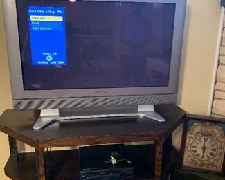 Flatscreen TV, TV stand, DVD player, and a few record albums