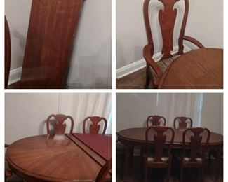 Dining table with custom pads, 2 leaves, & 6 upholstered Queen Anne chairs, in excellent condition.