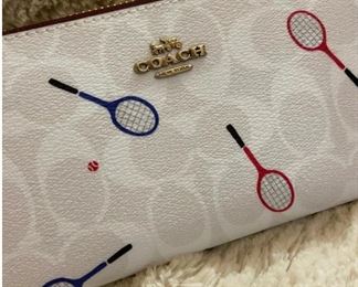 COACH Signature Canvas with Racquet Print; New with tags (5 available). Twelve credit card slots; Full-length bill compartments; Inside zip coin pocket; Zip-around closure Detachable wrist strap 7 1/2" (L) x 4" (H) x 1" (W) Style No. C8385.  Retail $288; Sale price $198