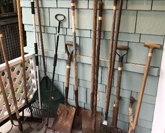 Assorted yard tools - rakes, shovels, axes & more