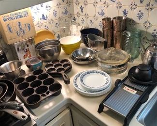 Cast iron muffin pan & aebleskiver pan, stainless bowls, vintage Pyrex casserole w/ cradle, Corelle dishes, Oxo mandoline