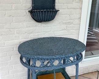 Wicker side table with clay wall fountain