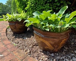 2 matching clay pots with plants