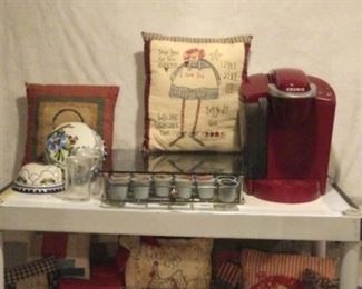 RED Keurig, didn’t even know they made these! And the drawer holding cups that it sits on, with lever to pull forward from under cabinet, plus the most wonderful pillow of Raggedy Ann’s birthday info, so fun, molds with rings to hang on wall, 