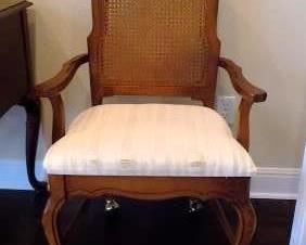 WICKER CHAIR ON WHEELS - SEAT FABRIC IS FRAYED