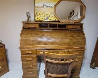 Beautiful roll top desk with matching file cabinet.