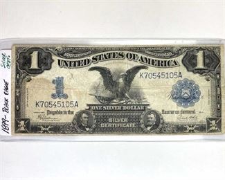 1899 Black Eagle $1 Silver Certificate, U.S. Stained. Other than the commonly seen stain, there doesn't appear to be any pinholes, rips, or tears. Overall excellent note to add to your collection!