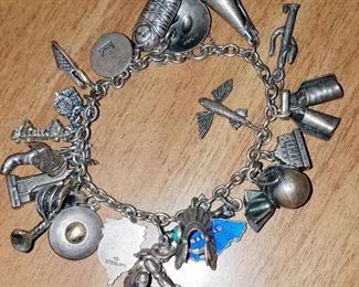 Much costume jewelry. Sterling souvenir bracelet