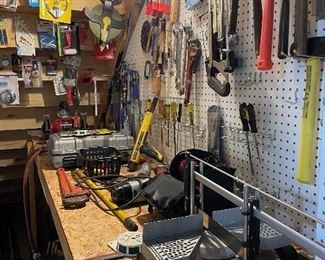 another view of the workbench and storage area; vice; pipe wrenches and more!