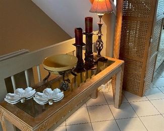 Glass-topped console table; bamboo 3-panel room screen; table lamp; candle holders and ceramic bowl with brass-footed stand