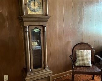 Grandfather clock by Waterbury Clock Company; side chair with cane seat and back