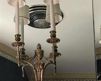One of a pair of ornate brass electric wall sconces 