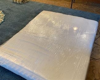 Queen Mattress with padded mattress topper.