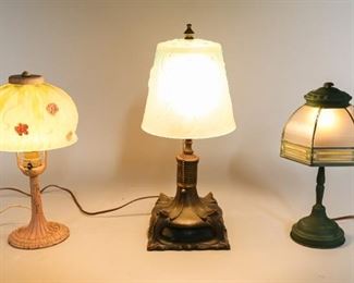 18	3 Boudoir Glass Shade Lamps	3 Boudoir frosted glass shade lamps. 2 lamps with painted metal stands, 1 lamp with bronze stand. Green shade stamped on the interior, Handel no 2702. Bronze lamp: 6" L x 6" W x 16" H. Crack to gilt on bronze stand. Wear to paint on green and pink lamps.
