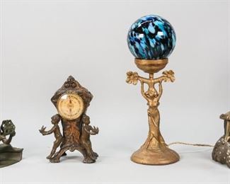 21	4 Art Nouveau Items	"4 Art Nouveau items. Painted metal table lamp with globe shade, brass figural table lamp, bronze figural clock with Taylor Humidiguide, bronze figural cigarette holder. Clock: 5"" L x 3"" W x 9"" H. Lamp with globe shade: 15"" H. Wear to paint on clock. 
"
