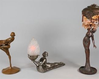 22	3 Art Deco Figural Tabletop Items	"3 Art Deco figural tabletop items. Patinated bronze figural lamp with beaded shade. Metal reclining woman lamp holding a frosted glass shade. Marked Chandler T. on the base lower left. Painted metal figural coin holder. Marked on the base, C 1922.
Lamp with beaded shade: 16 1/2"" H. Loss to beads on lampshade. Wear to paint on coin holder."
