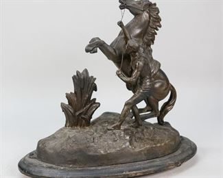 29	Metal Statue of Horse With Man On Wooden Base	"Metal statue of horse with man holding reins mounted on a wood base. 
Losses and wear throughout, paint loss to base, crack along bottom edge.
13"" H x 14"" L."
