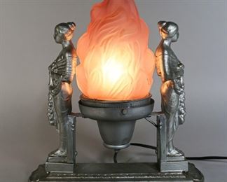 31	Art Nouveau Silver Tone Torch Table Lamp	"Art nouveau silver tone torch table lamp metal with 2 metal standing figures and glass torch lamp shade. Paint loss throughout.
12 1/2"" H x 10 1/4"" L x 4"" D."
