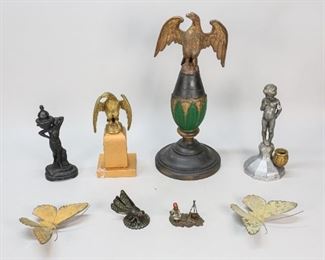 41	8 Metal Decorative Objects	"Grouping of 8 metal decorative items. Art deco nude incense burner, cherub incense burner, bronze dragonfly, pair of brass butterflies, brass eagle on wooden base, brass eagle on metal base, German Bergman cold painted style bronze. Larger eagle 17""H, German bronze 3""L x 2 1/4""H.
Losses and wear to paint decoration on wooden base of larger eagle, oxidation to eagle; losses to arm on cherub incense burner, later incense holder; brass eagle on metal base, glue residue to base and chips to gilt paint; nude incense burner lid bent and does not sit evenly, chips and losses to paint, cracks to base; oxidation to dragonfly, glue residue on underside; rust and oxidation to both butterflies; cracks to body on German bronze, paint loss to figure and hat, pot re-glued, supports over pot bent."
