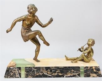 42	Bronze Grouping on Alabaster and Onyx Base	Manner of Chiparus, dancing flapper bronze and seated boy with pan flute gilt bronze. Both mounted on hardstone base comprised of alabaster, green and black onyx. 23" L x 6" W x 17 1/2"H. Dancing flapper loose in base. Chips to base, chip along edge of base.
