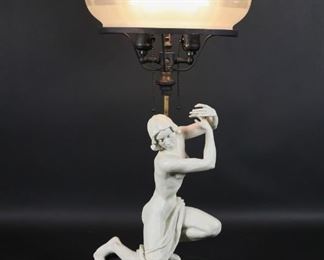 46	After Lore Friedrich-Gronau Sculpture Lamp	After Lore Friedrich-Gronau (German, 1908-2002) plaster sculpture of a woman, mounted as a lamp. Signed L.F. Gronau on base. With iridescent glass shade. 26" H. Wear to paint around circumference of base. Flake to rim of glass shade.
