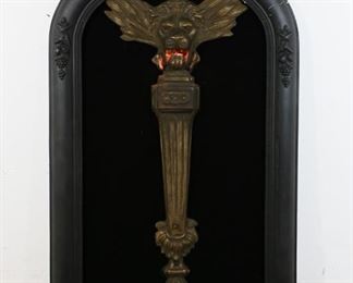 50	Victorian Illuminating Lion Wall Lamp	"Victorian illuminating lion wall lamp. 20th Century. A brass Victorian lion form wall lamp mounted in an ebonized composite frame. Lighting has been tested and works, illuminating the eyes and mouth of lion. Cracking and losses around upper edge of frame. Some rusting on brass. Hanger is broken. 
33"" H x 21"" L"
