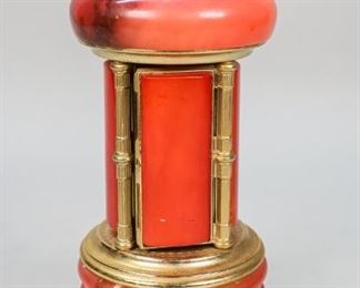 53	Italian Musical Cigarette Dispenser	Italian pink onyx and gilt metal cigarette dispenser music box. Marked on the underside Mod. Brev. Made in Italy. 11 1/4"H x 4 3/4"W at feet. Chips to onyx along bottom rim and on door edges, small chip on top.
