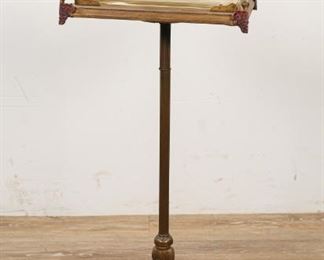 76	Art Deco Fishbowl on Stand	Hand painted brass stand with wooden top and glass fish tank. 23 1/2"H including fish tank, stand 11 3/4" x 8 1/4" x 27 1/2"H, tank 11"L x 7"D x 6"H. Base stamped 53 6 on underside. Wear and losses to painted decoration on base of stand, minor rusting and patina loss to stand, wear to gilt painting on wooden top, roughness and chips along rim of fish tank.
