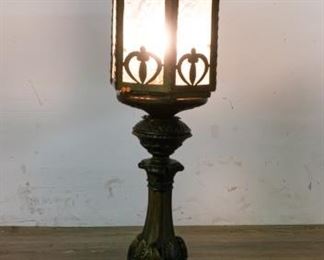 89	Brass & Glass Lantern Table Lamp	Brass and glass lantern style table lamp. Brass lamp base with brass and etched glass lantern style shade. 30 3/4"H. Some discoloration to patina on top, lamp slightly crooked on base, 3 metal accents on top detached but present, 1 missing; exposed wires on plug
