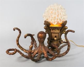 98	Metal Octopus Lamp with Pottery Coral Shade	"Painted metal octopus attached to a brass art deco lamp. With faux coral pottery shade. 17"" L x 11' W x 11"" H. Wear to paint on brass lamp. 
"
