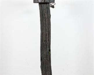 103	Found Object Faun Lamp	Composite faun sculpture on a tree trunk base with rock and driftwood. Brass lantern fixture with 1 bulb. On top of a composite tree trunk stand. 65" H x 11 1/2 base diameter. Later painting to each object. Crack to driftwood.
