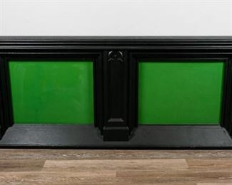 111	Art Deco Green Glass Illuminating Wall Console	"Art Deco green glass illuminating wall console. American, early 20th Century. Ebonized carved wood, green glass, switch to turn backlighting on and off. Lighting has been tested and works. Some wear to lower right corner. Back panel is loose on the left side.

31"" H x 79"" L x 6"" D

"

