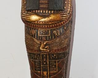 114	Egyptian Revival Style Sarcophagus Cabinet	"Egyptian Revival style sarcophagus form cabinet. Late 20th Century. New Kingdom style female form sarcophagus heavily painted and decorated. Lid opens on hinges to reveal six shelves. Magnetic clasp is broken on lid, wear and losses to bottom left side. 

49"" H x 12"" L x 12"" D"
