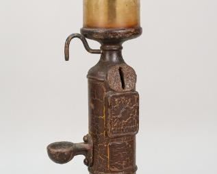 128	Nasco Iron Gas Pump Lighter Fluid Dispenser	Nasco metal gas pump style cigarette lighter fluid dispenser. 17 3/4" H x 5" base diameter. Wear to patina, crazing to patina throughout. Loss to patina at base. Residue to interior glass. Rust present throughout.
