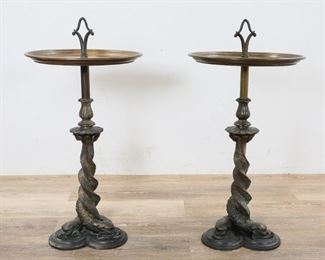 131	Pair of Bradley & Hubbard Brass Smoking Stands	Pair of B & H (Bradley & Hubbard) smoking stands. Dolphin form base. Both marked on the underside. 28"H from base to handle x 13 3/4" tray diameter. Discoloration to the metal of the trays.
