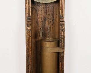 133	Brass & Wood Water Clock	Brass and wood water clock. Face inscribed with Arabic numerals. 2 brass weights on chains. Inscribed at the base. Decorated with angel bust and mill scene. 9" L x 4" W x 33 1/2" H (from base to top of clock face.) Wormholing to wood throughout.

