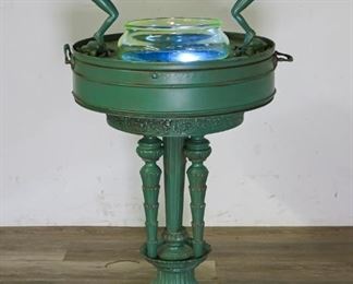 142	Art Deco Painted Metal Uranium Lighted Fishbowl	"In the style of Frankart, art deco painted metal stand with 2 divers diving into uranium glass fishbowl. Black light to the interior of stand. 35 1/2"" H (from bottom of base to top of diver) x 20"" stand diameter. Wear to paint on hands of divers, wear to paint in relief of stand. 

"
