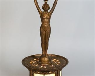 148	German Figural Art Deco Lamp	German figural art deco lamp, painted iron with slag glass shades. Marked on the underside with a Carpe Diem mark attributed to EG Zimmerman Hanau Germany. 17 1/4" H x 5 3/4" base diameter. Later paint application to figure. Loss to paint on legs, scratches to bowl.
