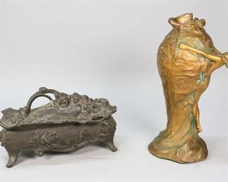 150	Art Nouveau Jewelry Casket and Pottery Vase	Weidlich Brothers figural metal art nouveau jewelry casket. Red velvet interior. Marked on the underside WB Mfg. Co. Art Nouveau painted pottery vase in the style of Van Briggle pottery. Jewelry casket: 10 3/4" L x 4" W x 5 1/2" H. Scuffing to the jewelry casket surface. Wear to figure's face on vase.

