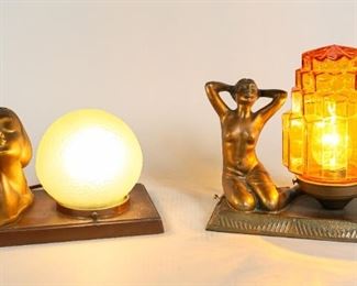 152	2 Figural Art Deco Table Lamps	2 figural art deco table lamps. Painted metal female face with green globe shade. Seated nude with tiered amber glass shade. Seated nude lamp: 8 1/4" L x 5" W x 8 1/2" H. Wear to paint on female face. Small chip to base, right side.
