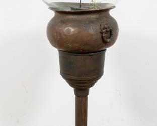 153	Neoclassical Brass Plant Stand with Glass Bowl	Neoclassical brass plant stand with glass bowl. Brass bowl with lion's head handles. On top of simple column form stand. 47 1/2" H (from base to top of glass bowl). Later painting to the stand, two cracks to the brass bowl, dents to the brass bowl, scratches to the surface.
