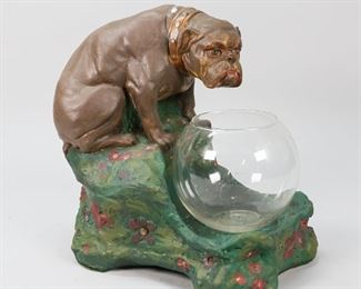 163	Early 20th Century Bulldog Pottery Planter	Bulldog pottery planter with glass bowl. Decorated with flowers on a green base. Marked within cartouche on back VL dated 1913. Impressed number 717. 10" L x 9" W x 11 1/2" H. Pitting to interior. Discoloration to the paint throughout. Loss to paint, top of bulldog.
