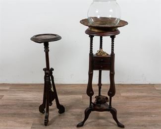 166	2 Wood Arts & Crafts Plant Stands	2 wood arts & crafts plant stands. 1 stand with 2 drawers, glass bowl. Later added fabric flowers and wood carved bass. Each having 3 carved feet. Plant stand with wood carved bass: 16 3/4" L x 16 3/4" W x 43 1/2" H (from base to top of glass bowl). Repairs to joinery. Crack to the drawers, left side. Crack to the base of 1 plant stand. Residue to top of plant stand. Wear to paint on top of stands.
