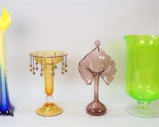 187	4 Piece Art Glass Grouping	4 pieces of art glass. Modern art glass Jack-in-the-pulpit style vase, unsigned, 19 1/2"H; large green glass vase / candle holder, 14"H x 8 1/2"-diameter at top; blown glass Jack-in-the-pulpit vase, 13 1/2"H; Pairpoint style etched amber glass vase / centerpiece with clear control bubble stem, 11 1/4"H x 7"-diameter at top. Bubbles in base of amber vase; large internal scratch or line in body of green vase, minor scratches throughout.
