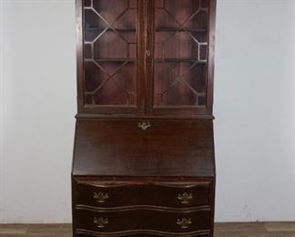 222	Chippendale Style Mahogany Secretary	"Chippendale Style mahogany secretary in a Georgian manner. English, Late 19th Century. Slant front desk bottom with serpentine drawers and ball-and-claw feet, top with glazed doors and broken arch pediment top. Key included. Loss to wood on doors and sides of drawer chassis, heavy wear to feet. Small scuffs to slant front. 

78"" H x 29 1/2"" L x 16"" D"
