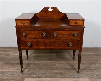 223	Edwardian Ladies Writing Desk	"Edwardian ladies writing desk. American, Mid 19th Century. Colonnade legs, dovetailed construction, button drawer pulls added in 20th Century. Wear and scratches to top surface, scratches above lower right drawer.  Dovetailing is loose on back carving and on top right drawer.

37"" H x 36"" L x 19"" D"
