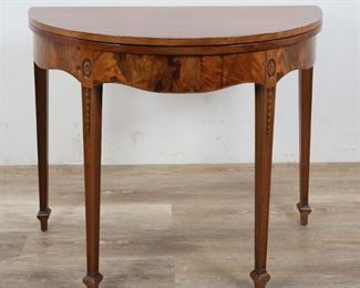 228	Federal Style Demilune Side Table	"Federal style demilune side table or console. American, 20th Century. Colonnade feet, burled apron, inlaid border on table top. Top extends to circular form with back legs extending as gate legs for support. Some scratches and wear to top.

28"" H x 36"" L x 18"" D
Extended: 28"" H x 36"" diameter"
