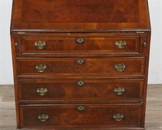 229	American Chippendale Slant Front Desk	"American Chippendale slant front desk. American, Late 19th/Early 19th Century. Slant front hinges and interior drawer knobs added in 20th century. Inlaid veneer, four drawers with brass batwing pulls, slant front with supports open to reveal writing surface with four letter cubbies and four drawer, one locking cubby door. Craquelere present on slant front and top of piece, wormholing on top and right side. Wear to front, top drawer offsets into chassis. Right slant front extension is hard to remove. 

38"" H x 30"" L x 17 1/4"" D"
