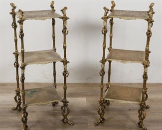 230	Pair of  Neoclassical Style Etageres	"Pair of Neoclassical style side etageres. French, Early 20th Century. Three tiers to each etagere, figural Athena corner mounts, grotesque mascarons, paw feet, gilt metal tiers and supports. Some wear to supports, oxidization and wear to lowest tier of one etagere.

31"" H x 14"" L x 14"" W"

