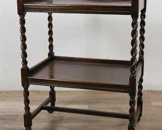        285	English Arts and Crafts Tiered Side Table	"English Arts and Crafts tiered side table. English, Early 20th Century. Mahogany, two tiers, barley twist form legs, metal casters. Some loss to left barley twist, some wear and light scratches to either side of lowest tier. Some slight wear to top of lowest tier.

32 1/2"" H x 24"" L x 16"" W"